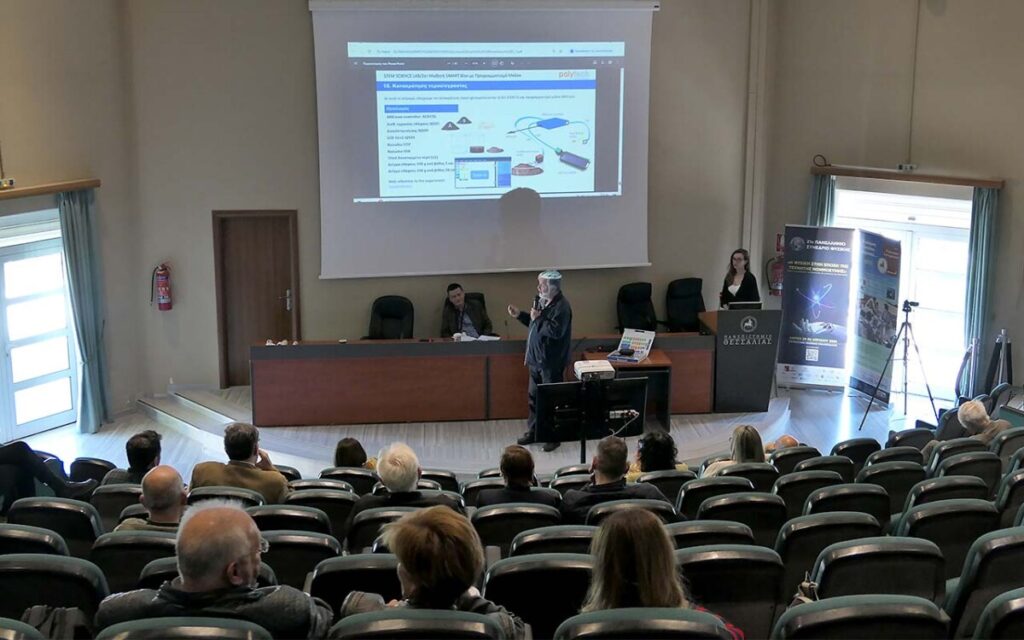 man speaking in audience with overehead projector