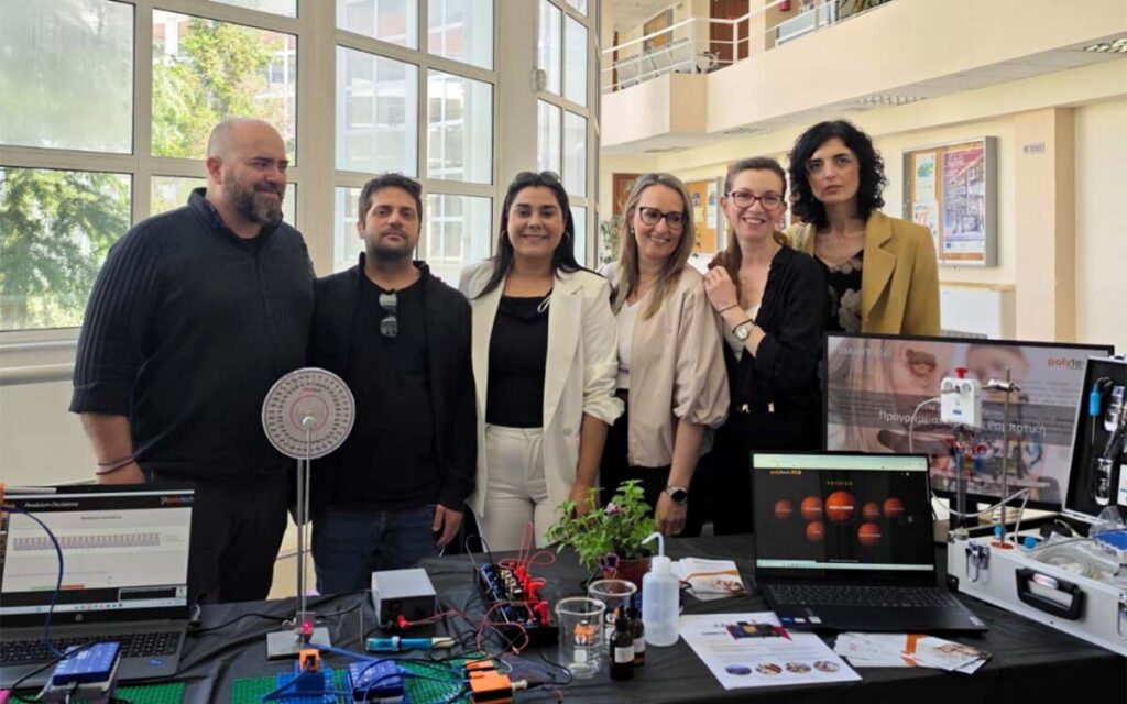 group of people displaying educational technology products